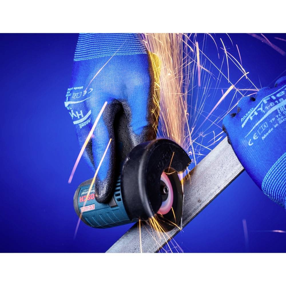 A person wearing blue gloves grinds metal with an electrically powered angle grinder, with sparks flying.