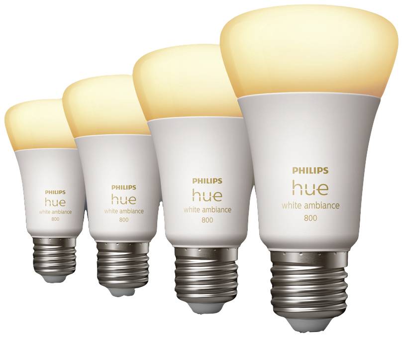 Four Philips Hue light bulbs in white tones, generating different intensities of warm light. Energy-efficient smart home lighting.