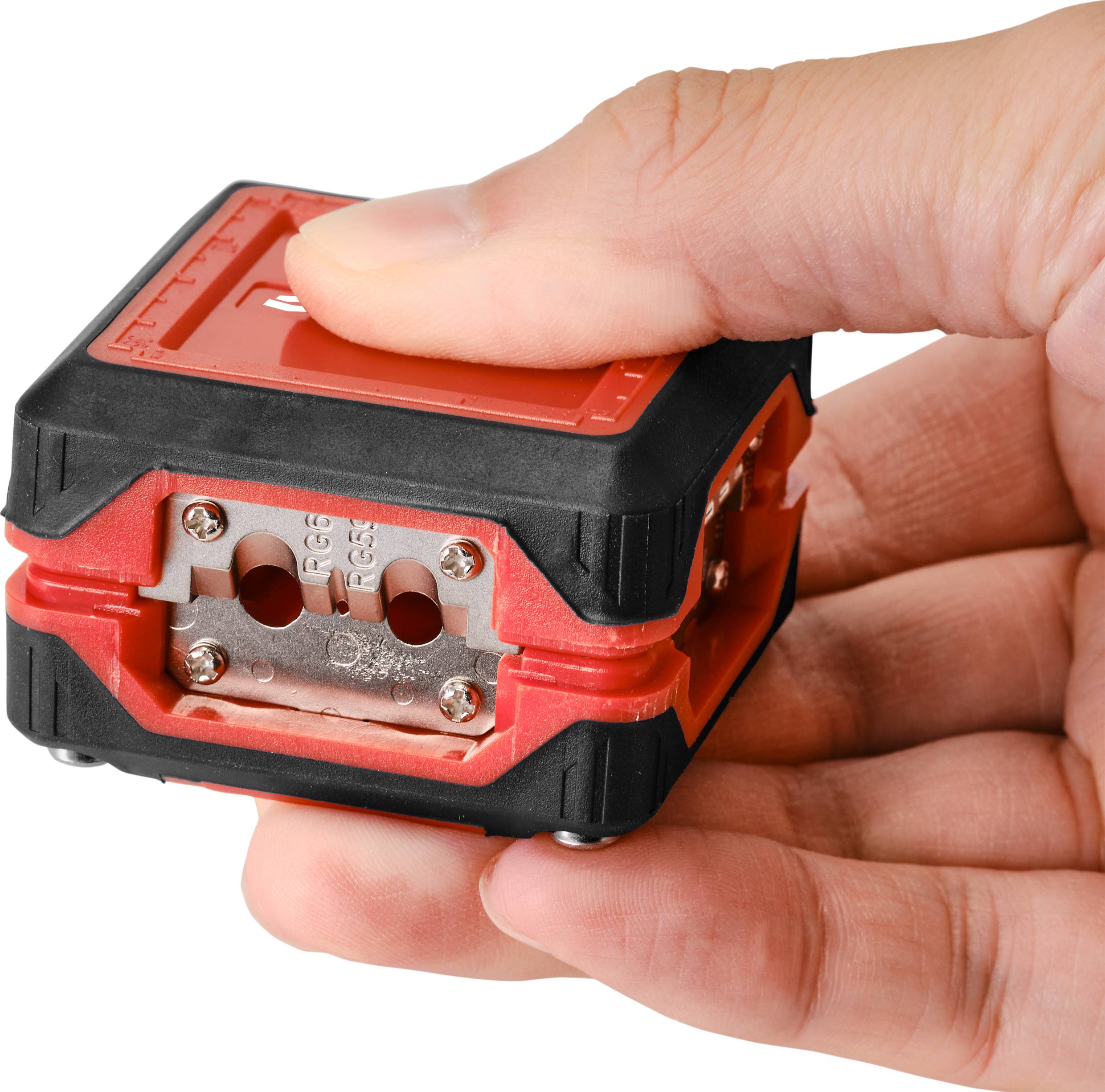 A hand is holding a red two-hole pencil sharpener with a black border. A finger is gently pressing on the upper part of the sharpener.