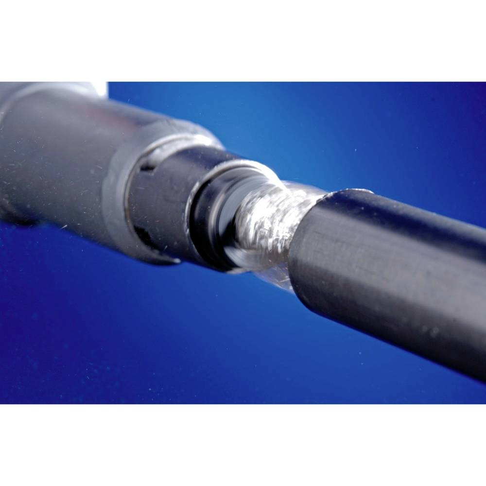 Close-up of a metallic tool in a bluish light. It shows the detail of a drill or turning tool at work.