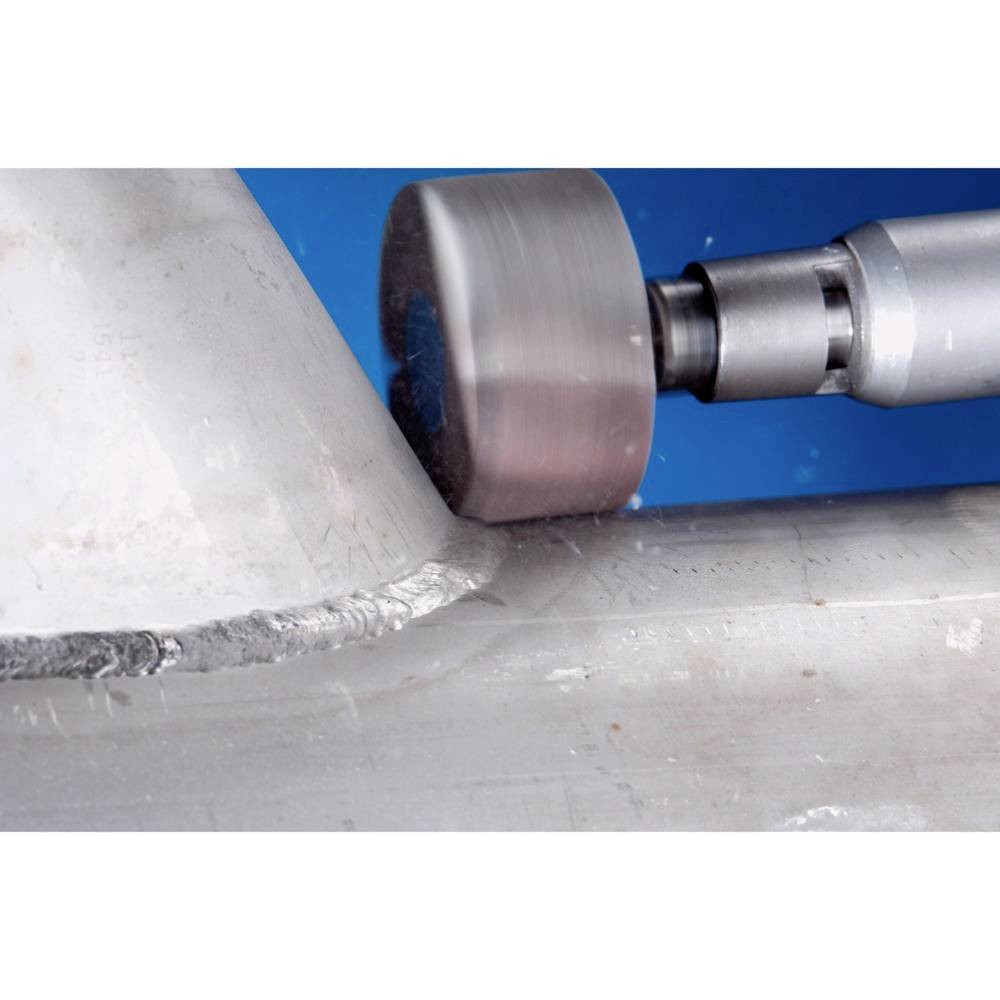 A metallic tool mills precisely on a workpiece. The scene depicts industrial processing with an exact cutting operation.