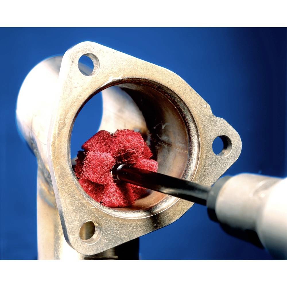 A metallic pipe being cleaned internally with a red abrasive pad, shown against a blue background.