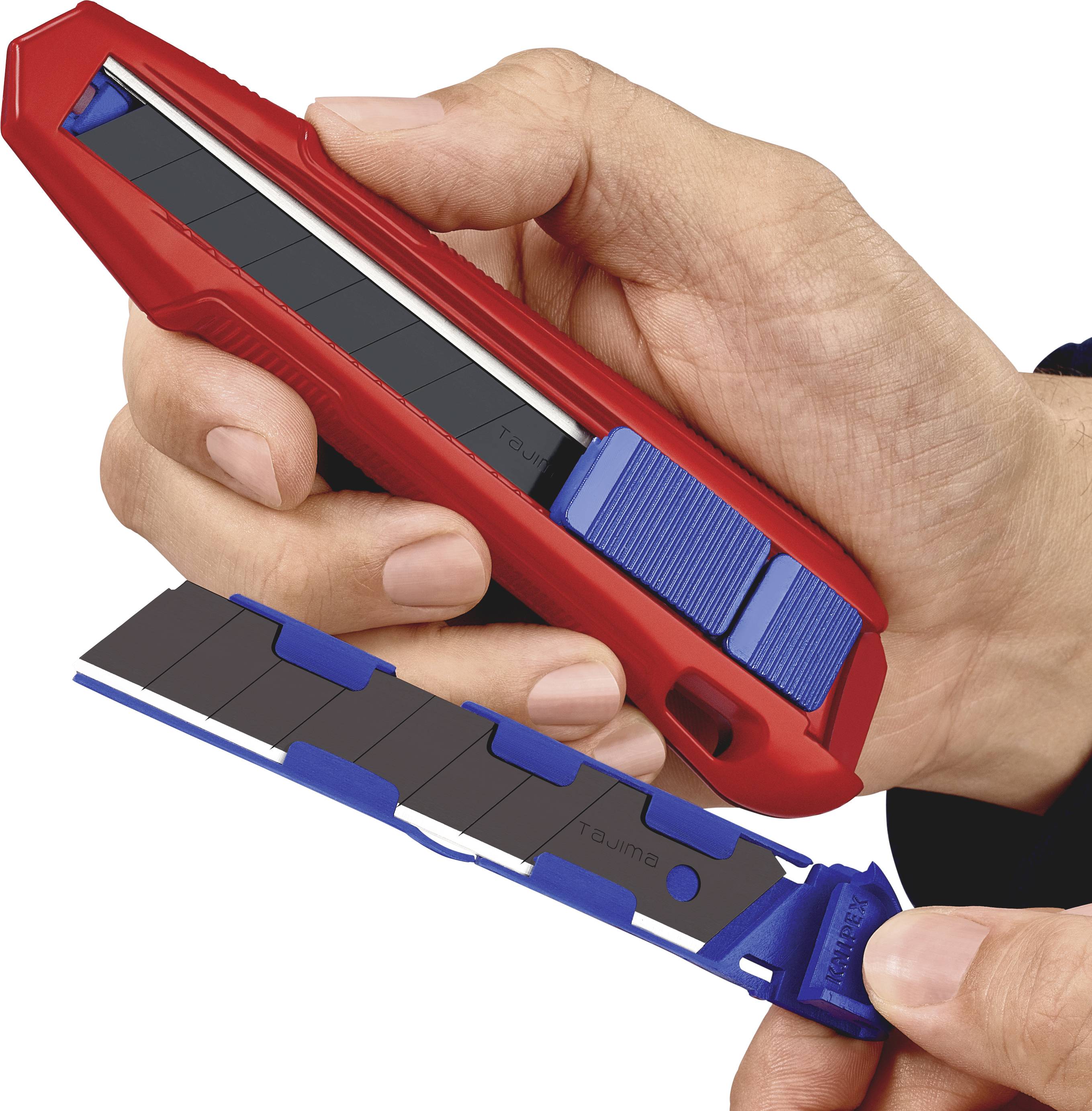 A hand is holding a red utility knife with a blue blade, while the other hand displays a spare blade.