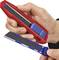 A hand is holding a red utility knife with a blue blade, while the other hand displays a spare blade.