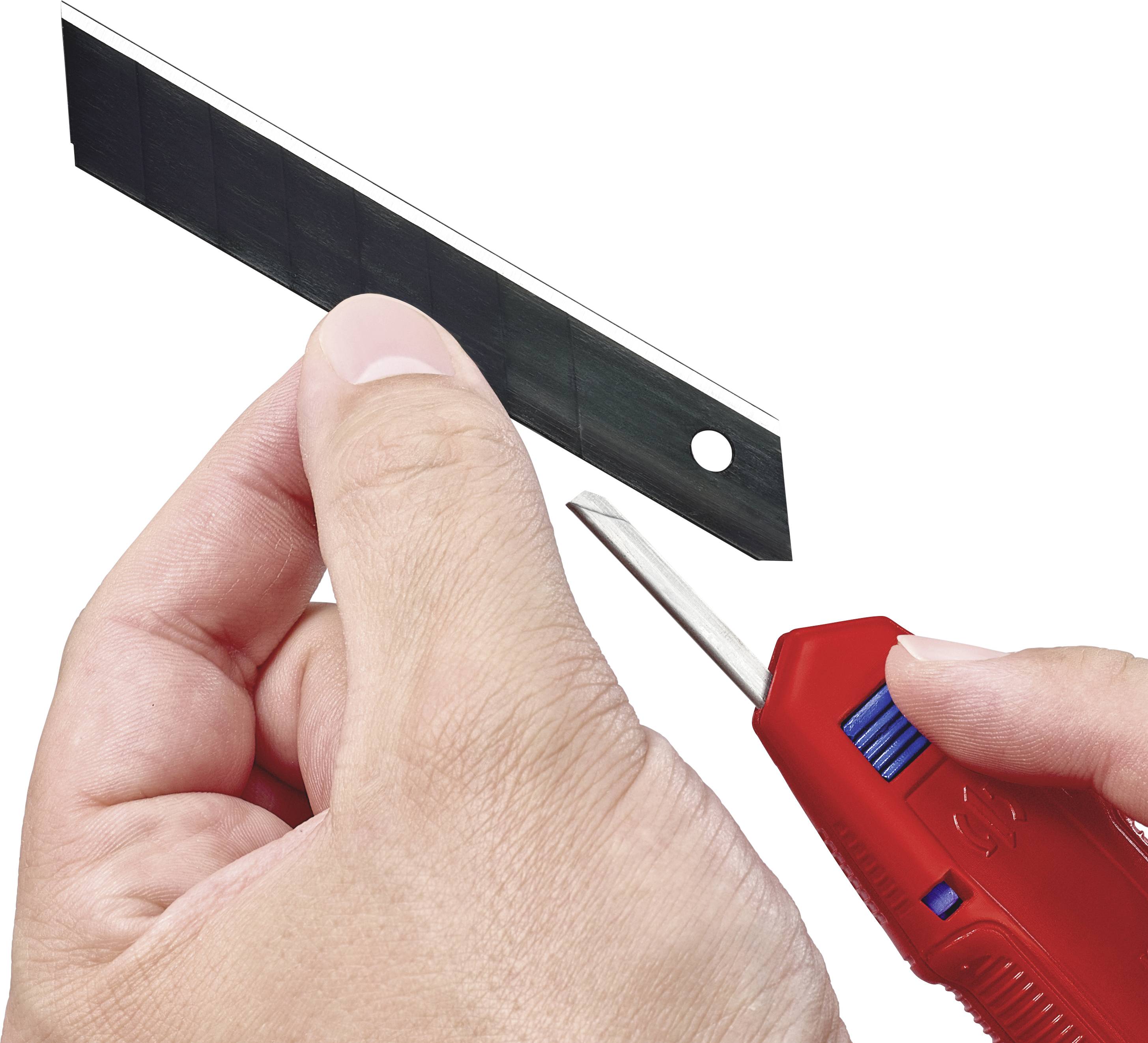 'A hand is holding a red mini screwdriver, which is gripping a thin black blade with a hole at its end.'
