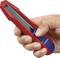 A hand is holding a red Stanley knife with a blue slider.