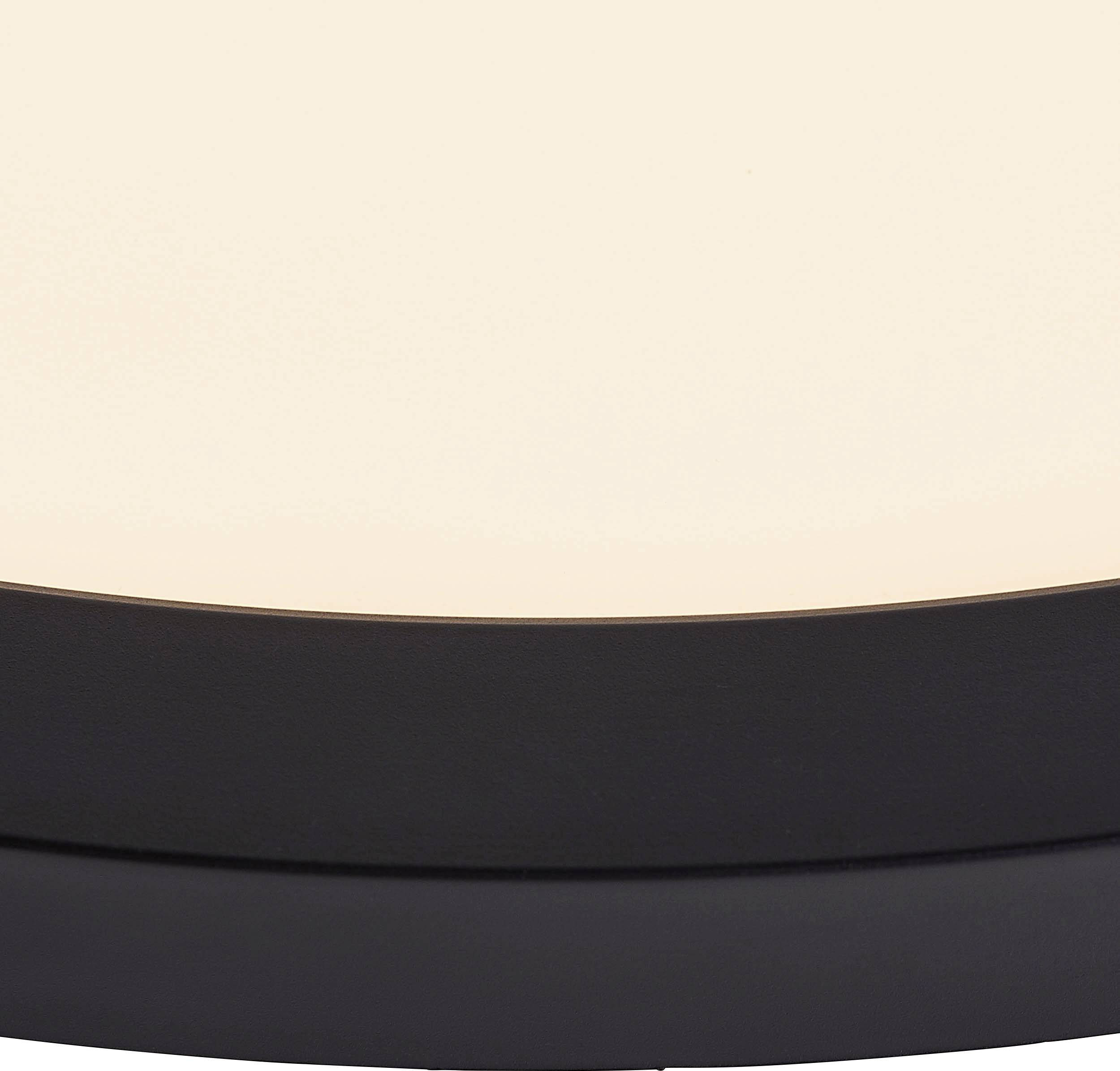 A round, minimalist ceiling light with a black frame and warm, white light illuminates evenly.