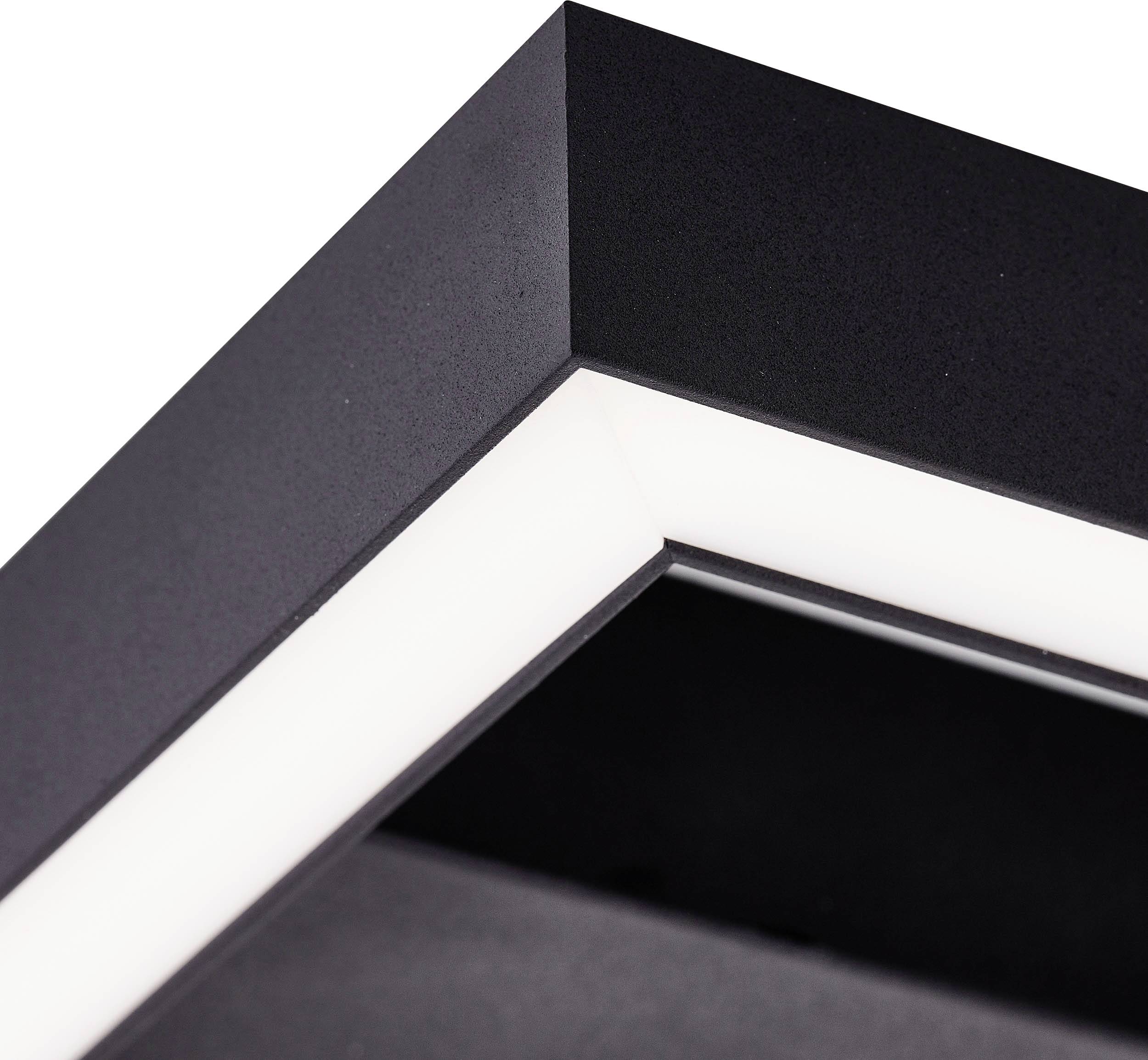 Black, modern picture frame in close-up; shows L-shaped edge with white inner border. Suitable for contemporary living spaces.