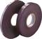Two rolls of dark adhesive tape standing side by side.
