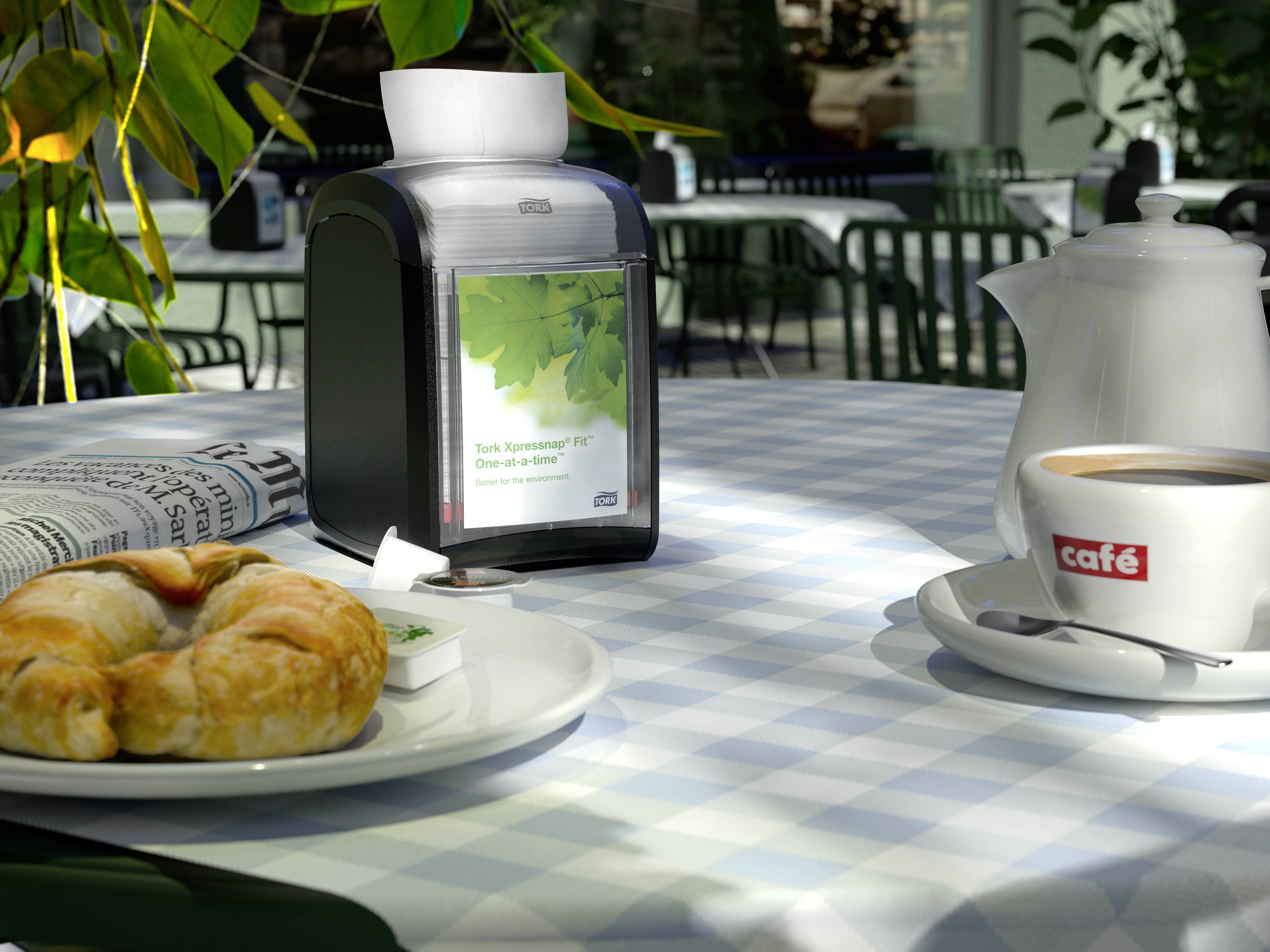 A set table in a café: pastries, coffee, napkin holder, newspaper. Outdoor seating area with plants blurred in the background.