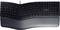 Ergonomic black keyboard viewed from above, slightly curved with a detachable wrist rest, cable connection at the top.