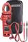 Red multimeter with clamp function, LCD display and test leads, pictured in front of a black Benning bag.