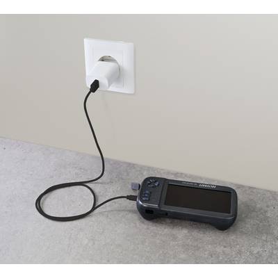 A portable electronic device is being charged via a USB cable at a wall socket.