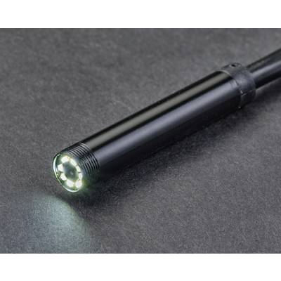 Close-up of a black endoscope with illuminated LED lights at its tip, lying on a grey background.