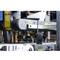 A radio sits on an industrial conveyor belt in a factory environment, symbolising communication and control in the industrial process.