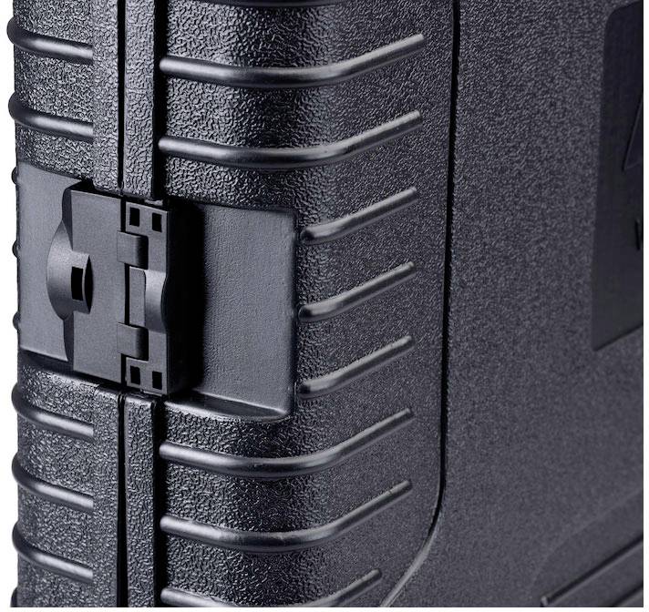 A detailed close-up of a black hard-shell suitcase, showing a close view of the locking mechanism and textured surface.