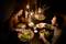 A man and a woman are having dinner together in a room with cosy lighting. Salads and drinks are placed on the table.
