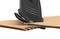 A knife cuts through clean, safe fabric over cardboard. The image shows a close-up of the cutting process on corrugated cardboard.