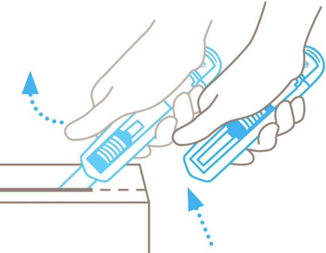 Two hands hold a Stanley knife and cut a cardboard box. One hand keeps the box stable while the other guides the blade.