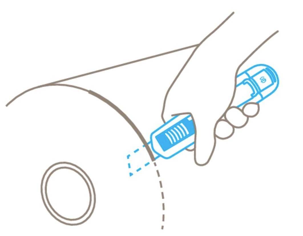 A hand holds a blue spray device, aiming it at a curved surface with a target point.