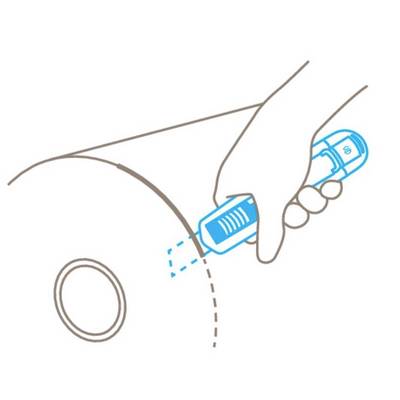 A hand holds a blue spray device, aiming it at a curved surface with a target point.