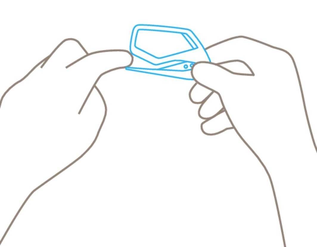 Two hands are holding and shaping a small, thin device.