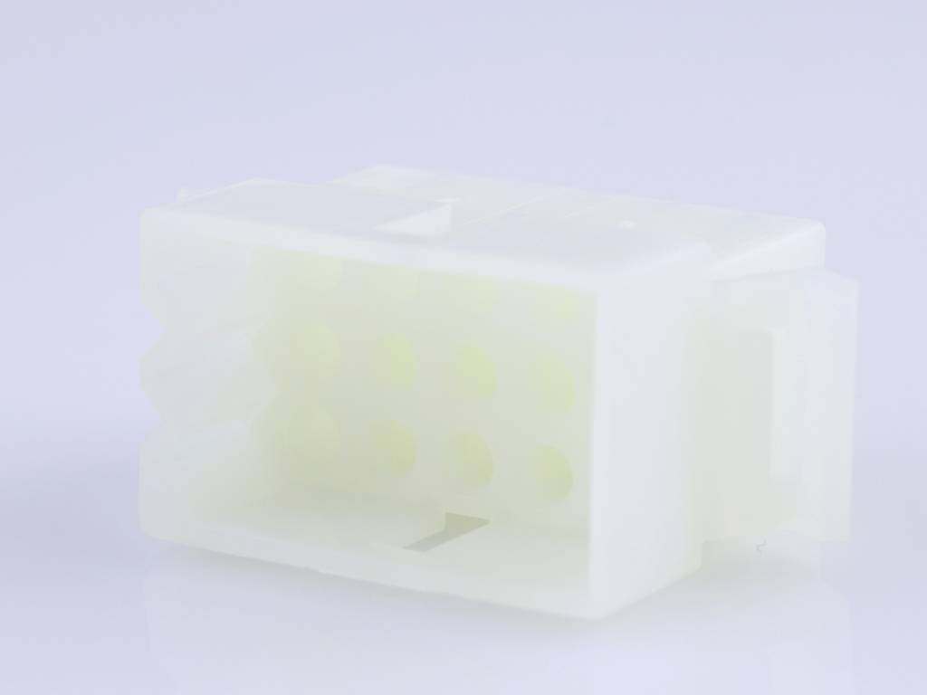 A white, rectangular plastic plug with multiple holes, lying on a smooth, reflective surface.