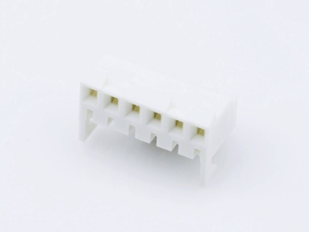 A white plastic plug with six rectangular slots, suitable for electronic connections.
