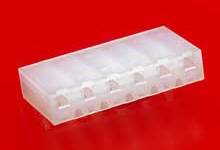 A white, rectangular plastic container against a red background. The container has six separate compartments.