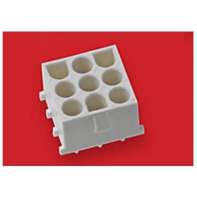 White, square plastic block with nine round openings on a red background.