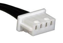Plastic plug with four terminals and black cables, commonly used in small electronic devices for power supply.