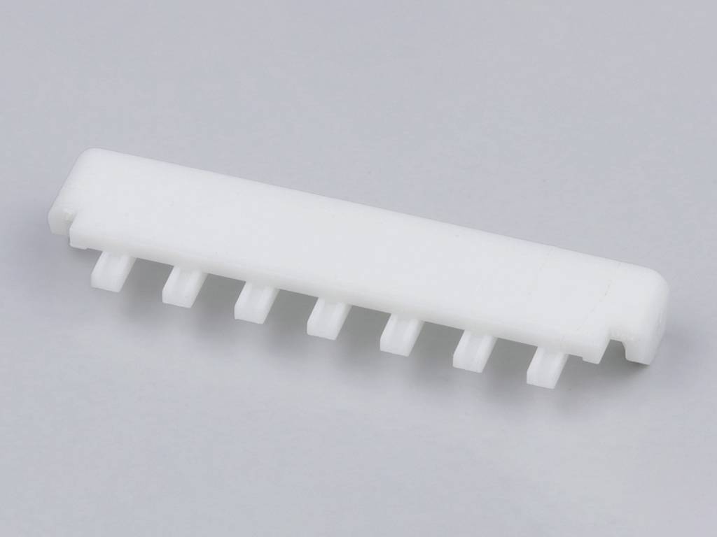 White, rectangular plastic plate with seven evenly distributed teeth on the underside against a grey background.