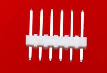 A white plug connector with seven metal pins on a red background, possibly an industrial or electrical component.