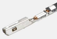 Metallic rectangular connector with a shiny surface. Used for electrical connections.