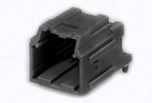 A black plastic plug with a rectangular aperture and a ribbed design. It is used for connecting electrical cables.