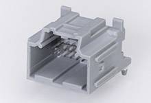 Grey, rectangular plastic plug with multiple metal pins inside. Likely used for electronic connections.