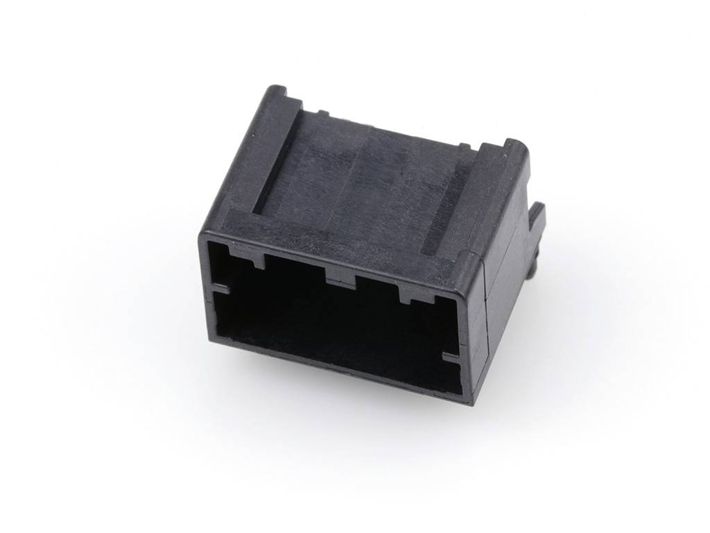 A black plastic plug with a rectangular shape, lying on a white background.