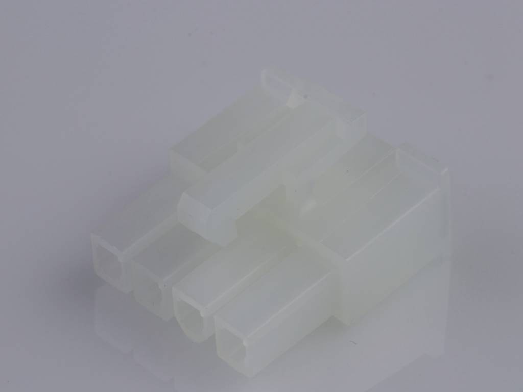 A white, translucent plastic plug, possibly an electrical connector, is resting on a grey surface.