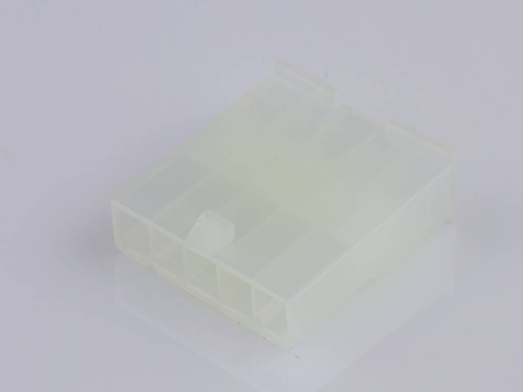 A square, white plastic connector plug with multiple openings, lying on a smooth, bright surface.