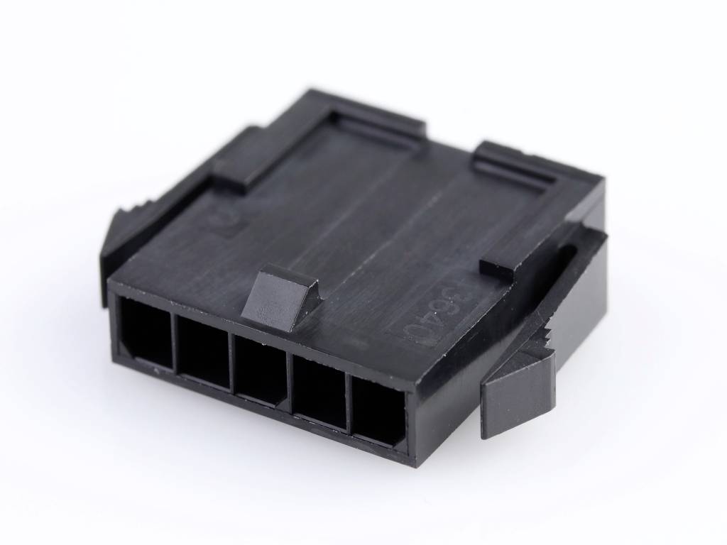 Black plastic plug with four rectangular openings, likely for connecting electronic components.