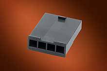 A black rectangular plastic plug with three open connection points against an orange background.