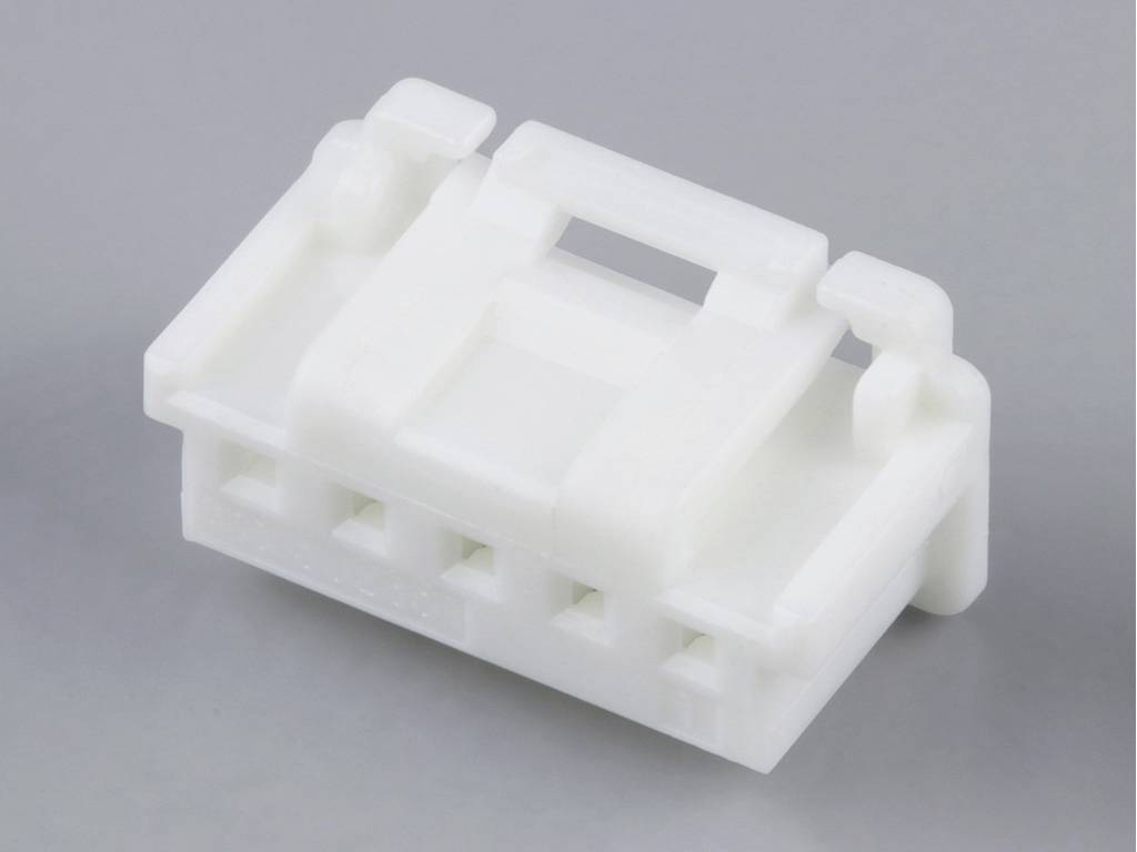 White plastic housing for electronic connectors, with multiple slots visible.
