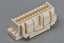 Beige plastic plug on a grey background, side view.