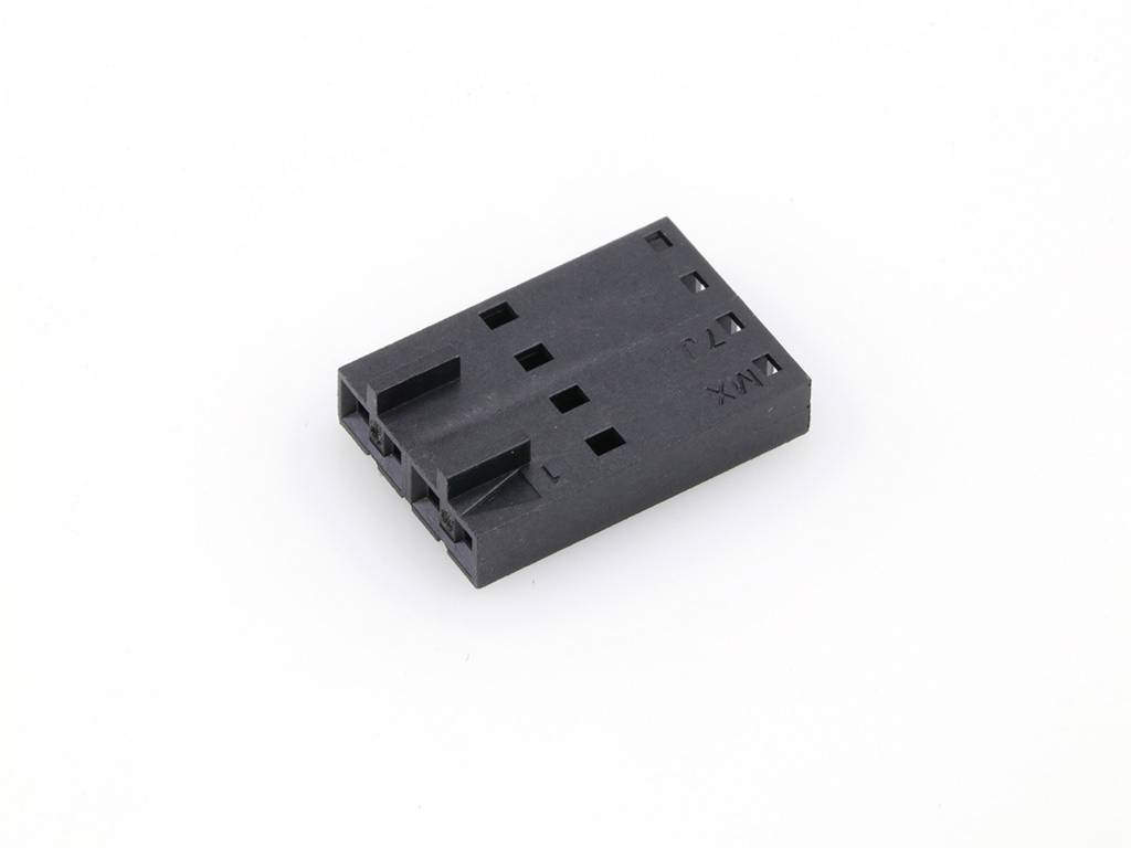 A black, rectangular plastic plug with multiple holes, suitable for electronic connections, against a white background.