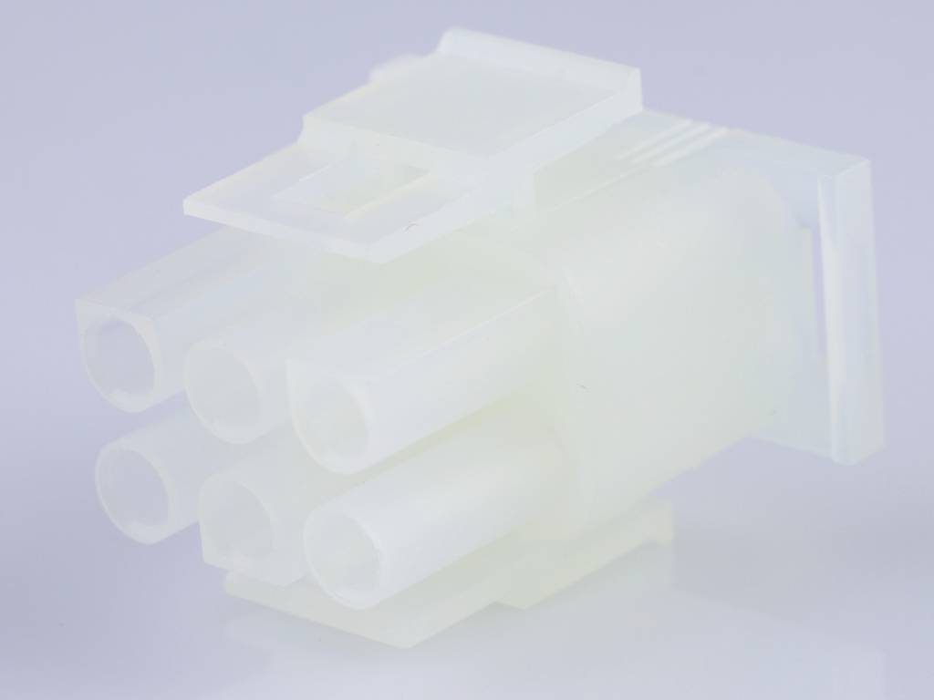 A white, six-pin plastic plug in close-up, presumably part of an electronic or cabling system.