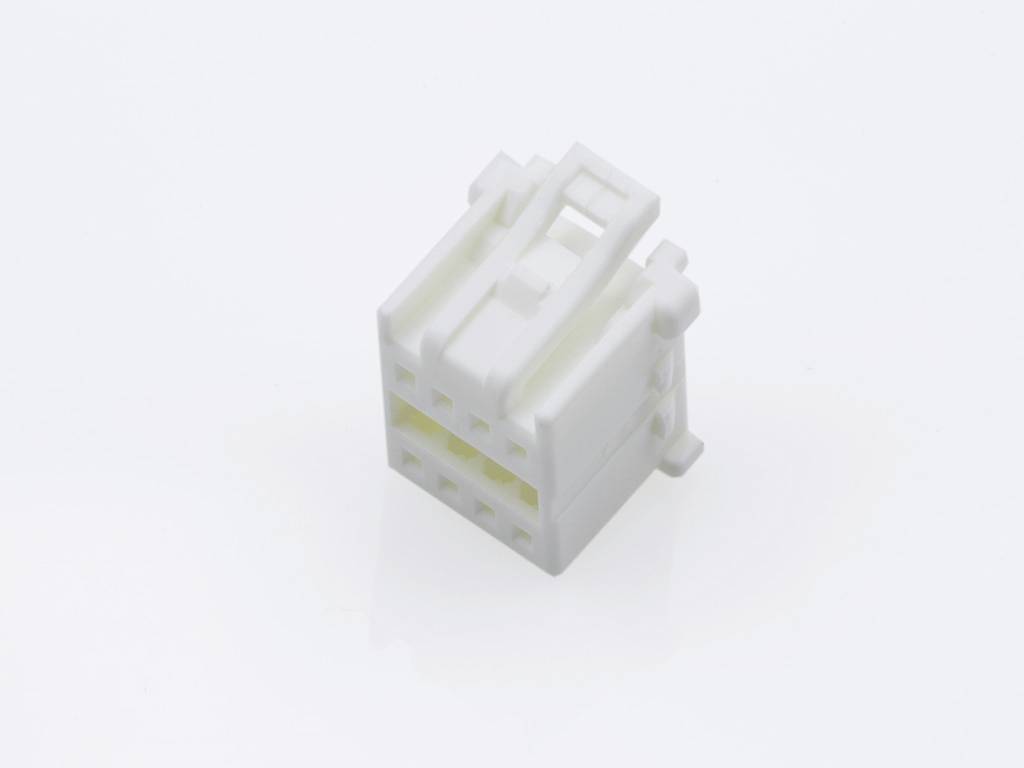 A white, rectangular plastic plug with multiple openings, suitable for electrical or mechanical connections, on a white background.