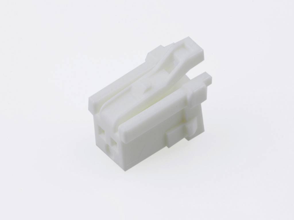 A white, rectangular plastic injection-moulded part with multiple edges and recesses, set against a light background.