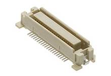 A beige connector with multiple metal pins for electronic circuit boards, rectangular in shape with a protective border.