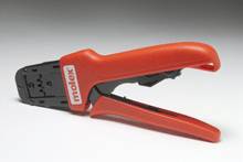 Crimping pliers with a red handle, positioned sideways. Marked with 'molex'. Used for cable processing and connection terminals.
