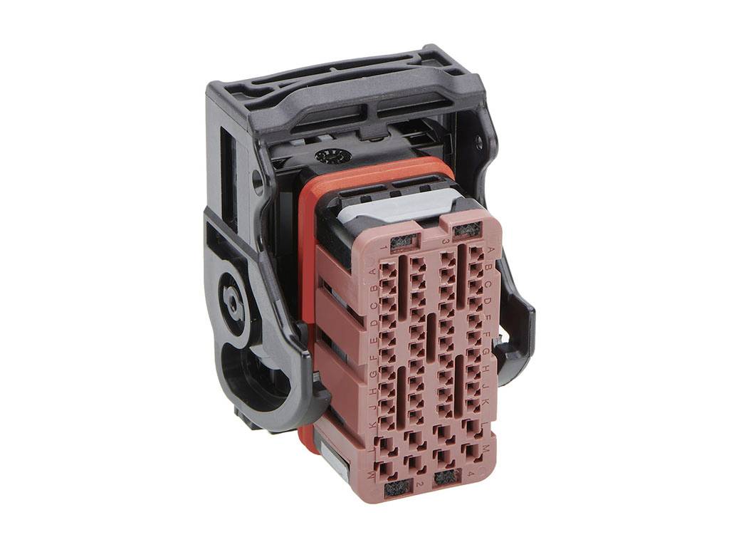 A rectangular, multi-coloured vehicle electrical connector with numerous pins, used in automotive electrical connection systems.